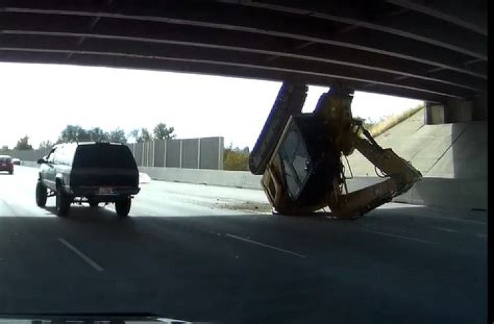Lane closures on I-215 after excavator knocked off of trailer